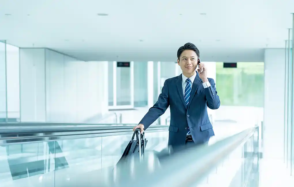 Businessperson walking through an office building during a business trip